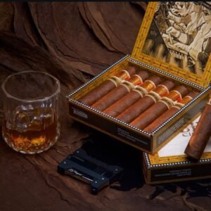 Open box of cigars, whiskey glass, and lighter on tobacco leaves.