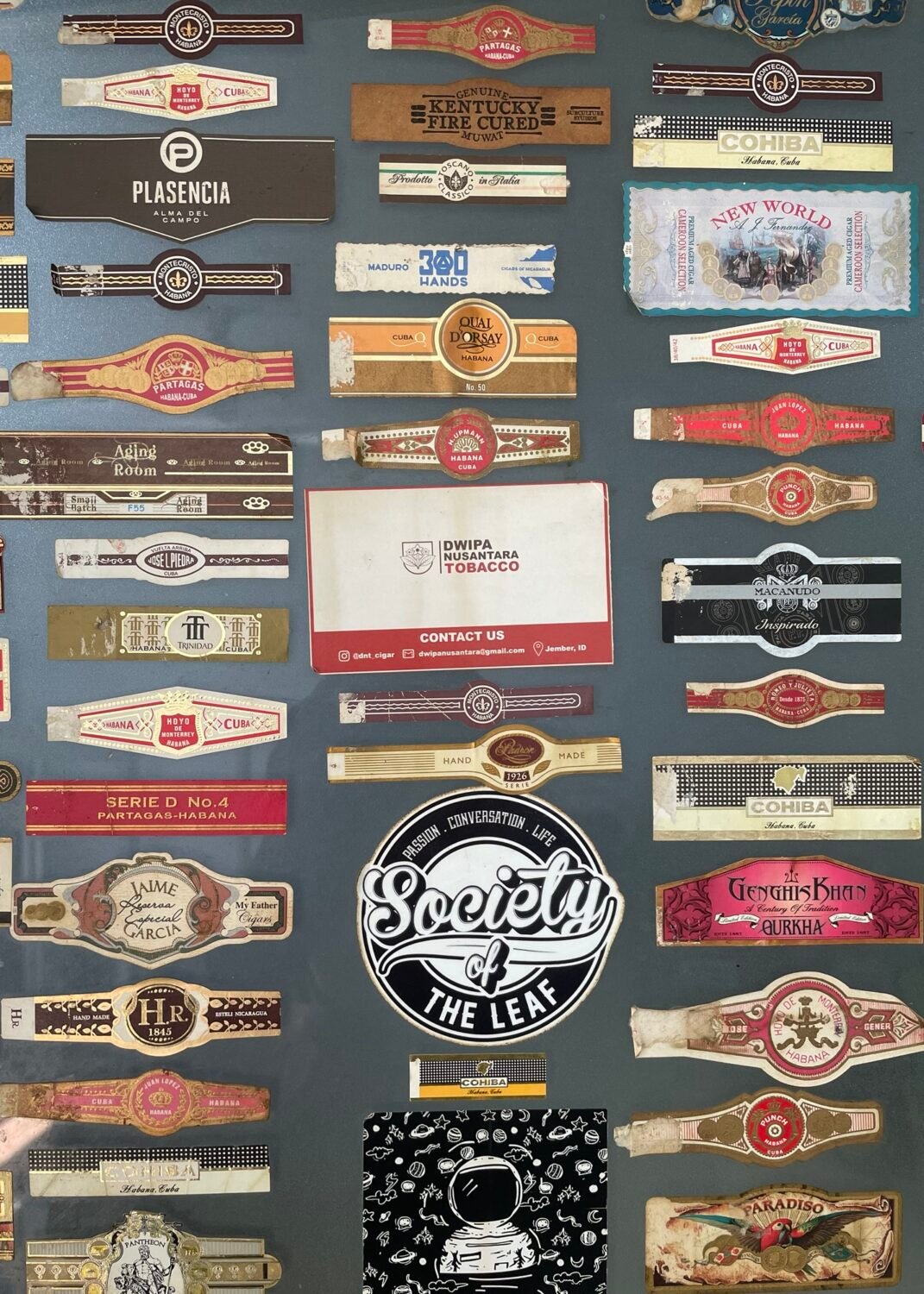 Collection of vintage and modern cigar bands and labels.